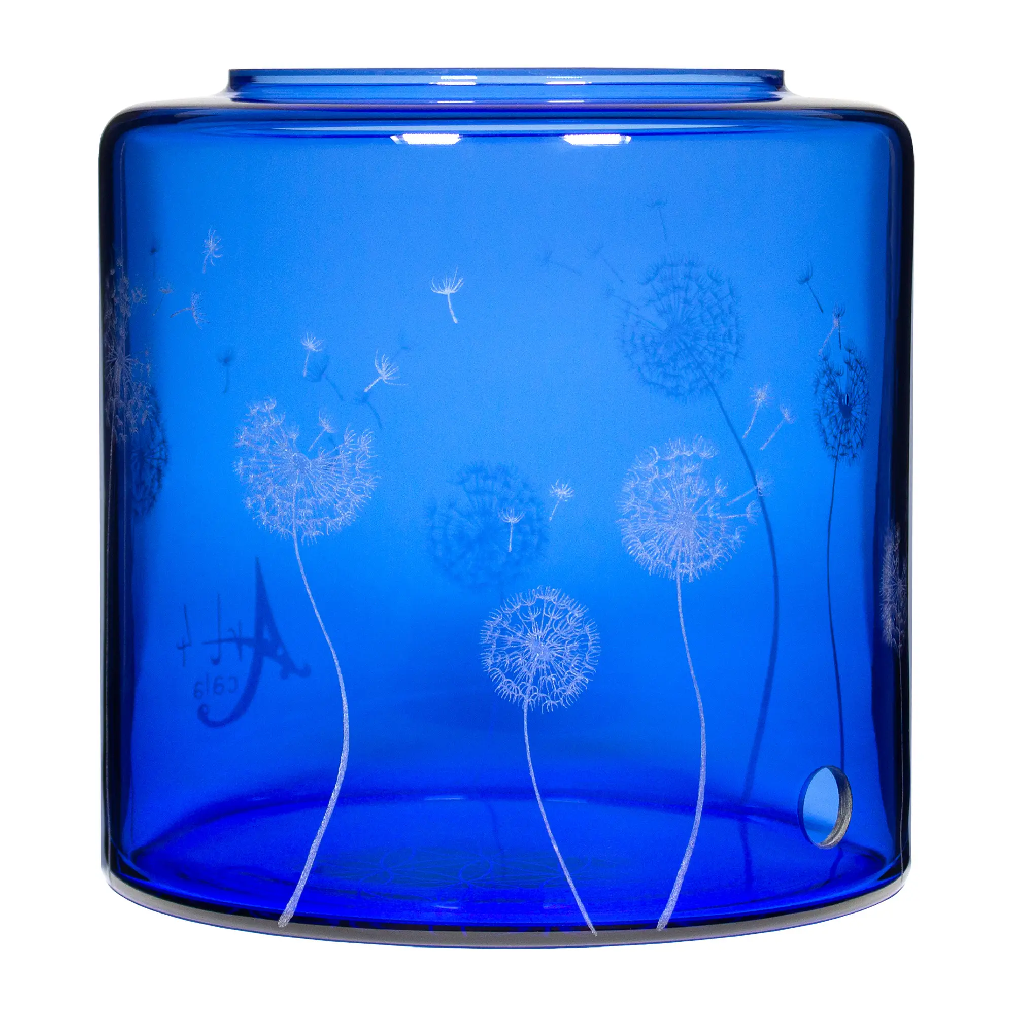Ein Acala Wasserfilter Mini mit einer Handgravur. Die Gravur zeigt, auf blauem Glas, ganz viele Pusteblumen und einige samen die aus der Pusteblume herausfliegen.Ansicht von vorne links.